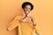 African american man with afro hair wearing cervical neck collar smiling in love showing heart symbol and shape with hands