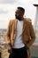 African american man attractive posing leaning on the railing of a roof terrace in Madrid