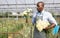 African american man with bouquet of fresh cut carnation flowers