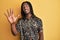 African american man with braids wearing leopard animal print shirt showing and pointing up with fingers number five while smiling