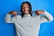 African american man with braids wearing turtleneck sweater smiling cheerful showing and pointing with fingers teeth and mouth