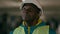 African american man builder inspector architect developer in protect helmet inspect underground parking lot think