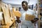 African american man choosing wooden cutting board in store