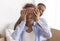 African American Man Covering Wife`s Eyes Before Showing Their Apartment