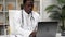 African American man doctor typing text on keyboard laptop in clinic office