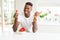 African american man eating fresh healthy strawberries very happy pointing with hand and finger to the side