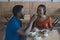 african american man feeding girlfriend with dessert on romantic date