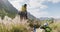 African american man giving piggyback ride to his wife while trekking in the mountains