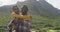 African american man giving piggyback ride to his wife while trekking in the mountains