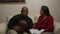 African American Man and Hispanic Woman Read and Discuss Bible