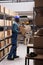 African american man holding package in product distribution warehouse