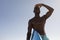 African American man holding surf board on the beach