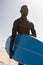 African American man holding surf board on the beach