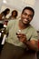 African-American man holiding a wine glass in a restaurant