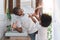 African American Man and little boy having fun laughing with shaving foam on face in bathroom at home