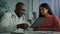African american man medical worker talk to sick female patient show health test result on digital tablet give