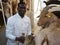 African-American man milking goats