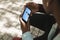 African american man in park watching male athlete throwing discus on smartphone