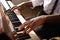 African-American man playing piano, closeup. Talented musician