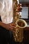 African-American man playing saxophone, closeup. Talented musician