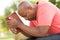 African American man praying and reading the Bible.