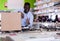 African american man with purchases box in household shop