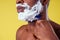 African-american man with razor and shaving foam on his face