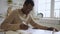 African American man realtor draws up documents for a new property with a laptop sitting at a table, making notes in a