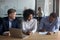 African American man signing contract with business partners at meeting