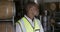 African American man smiling at camera and wearing high visibility vest