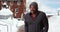 African-American man standing in the snow outside on frosty morning