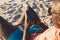 African american man in sunglasses sitting in deckchair using smartphone on sunny beach