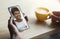 African american man talking to his friend online, using smartphone and drinking coffee in cafe, collage, closeup