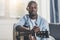 African american man tuning acoustic guitar