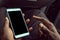 African American man using mobile smart phone with blank black screen. Mock up of a Black man holding device and touching screen.