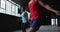 African american man and woman skipping rope in an empty urban building