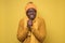 African american man in yellow clothes scarf and hat freezing in warm clothing.