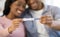 African American married couple showing positive pregnancy test, selective focus