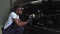 African American mechanic, applies polishing paste, erases the paste on the car door. Restoration of car parts after