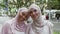 African american and middle eastern muslim ladies in traditional headscarfs smiling to camera, bonding together outdoors