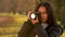 African American mixed race biracial teenager young woman using a digital camera outside at sunset taking photographs