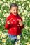 African American mixed race girl sitting blowing bubbles in a field of daffodils