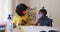 African american mother and daughter in home wearing face masks