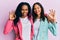 African american mother and daughter wearing business style smiling positive doing ok sign with hand and fingers