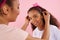 African American mother puts crown on head