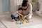 African American mother and toddler girl playing with wooden blocks