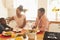 African American mother wiping her son mouth with napkin