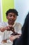 African American Muslim man delicately takes dates to break his fast during the Ramadan month, seated at the family