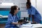 African american nurse discussing sickness symptoms with woman coworkers