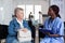 African american nurse filling out elderly woman admission paperwork